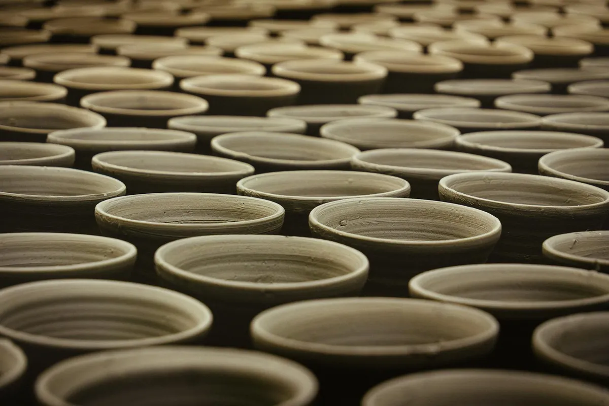 A matte-finish Pueblo blackware jar on a neutral studio surface